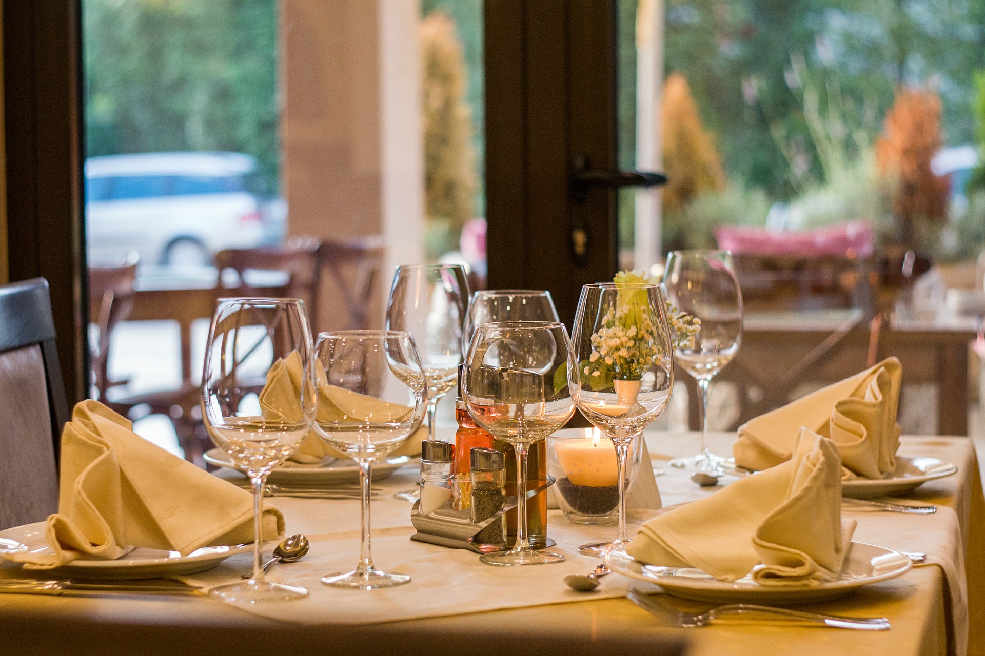 A table full of cutlery, glasses and plates