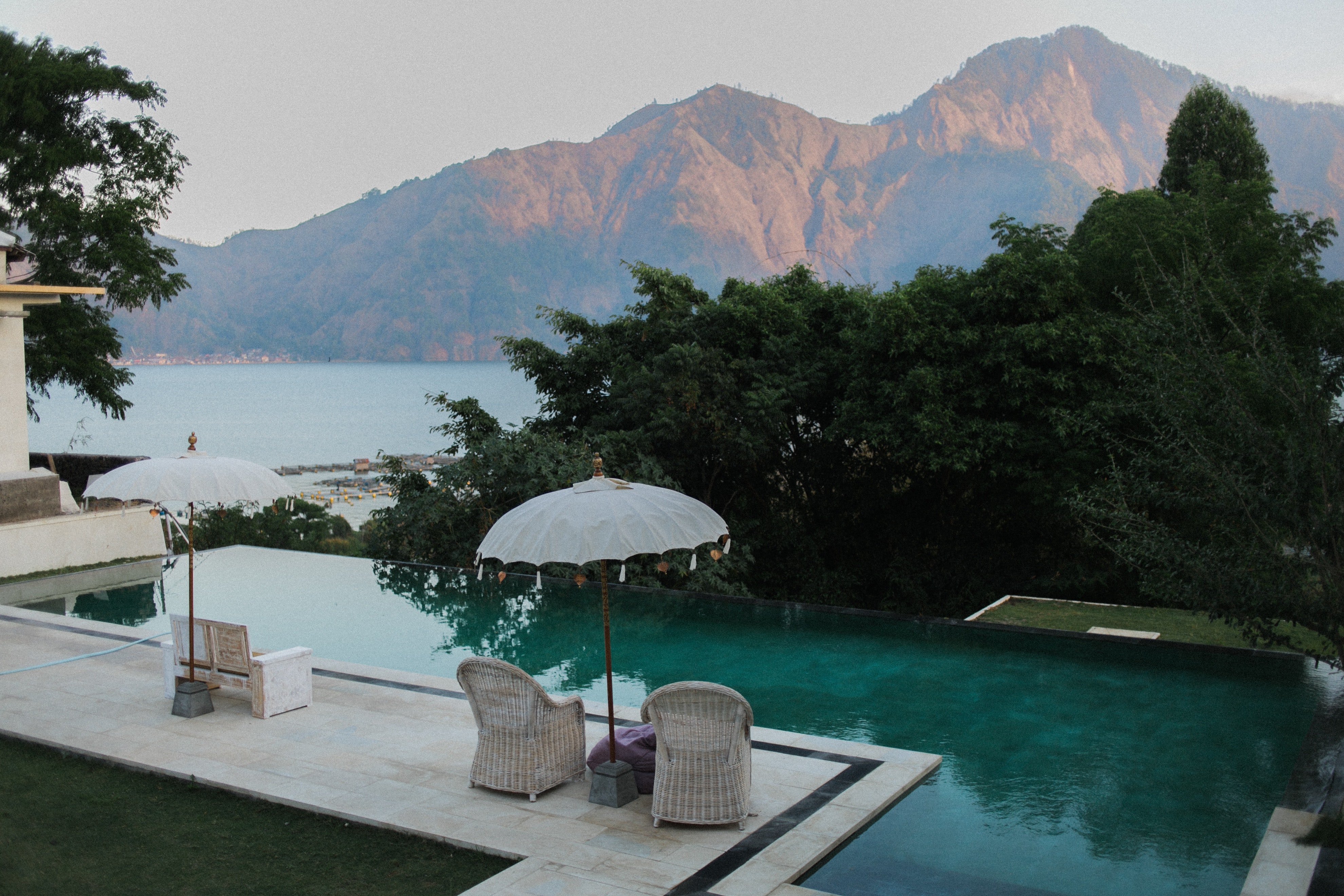 A view of mountains from a room with a pool