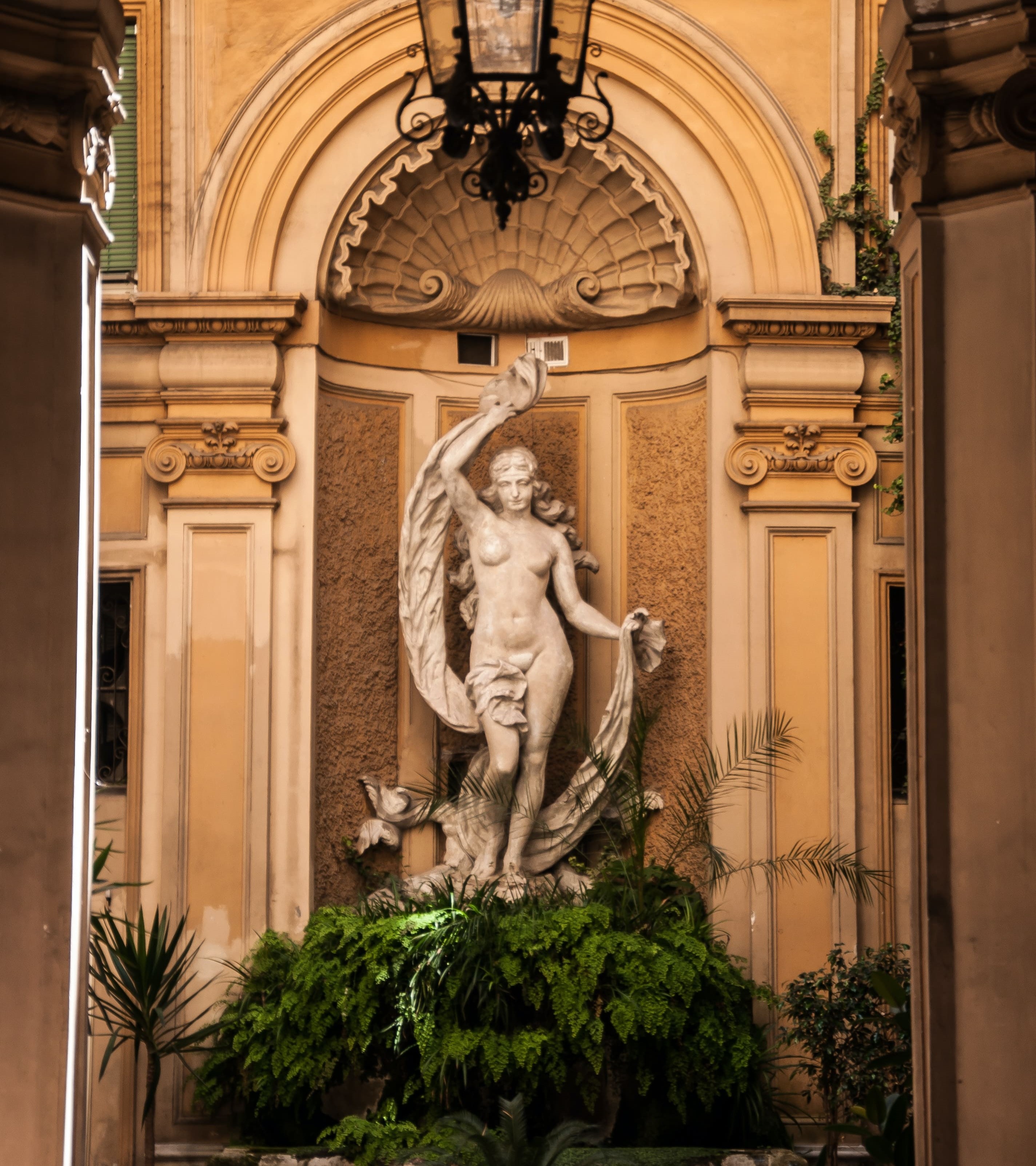 A statue above some bushes